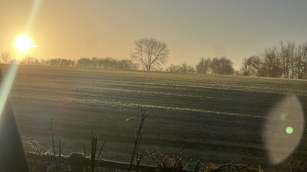 A frozen field at sunrise symbolising the UK tax threshold freeze and its impact on income and savings.